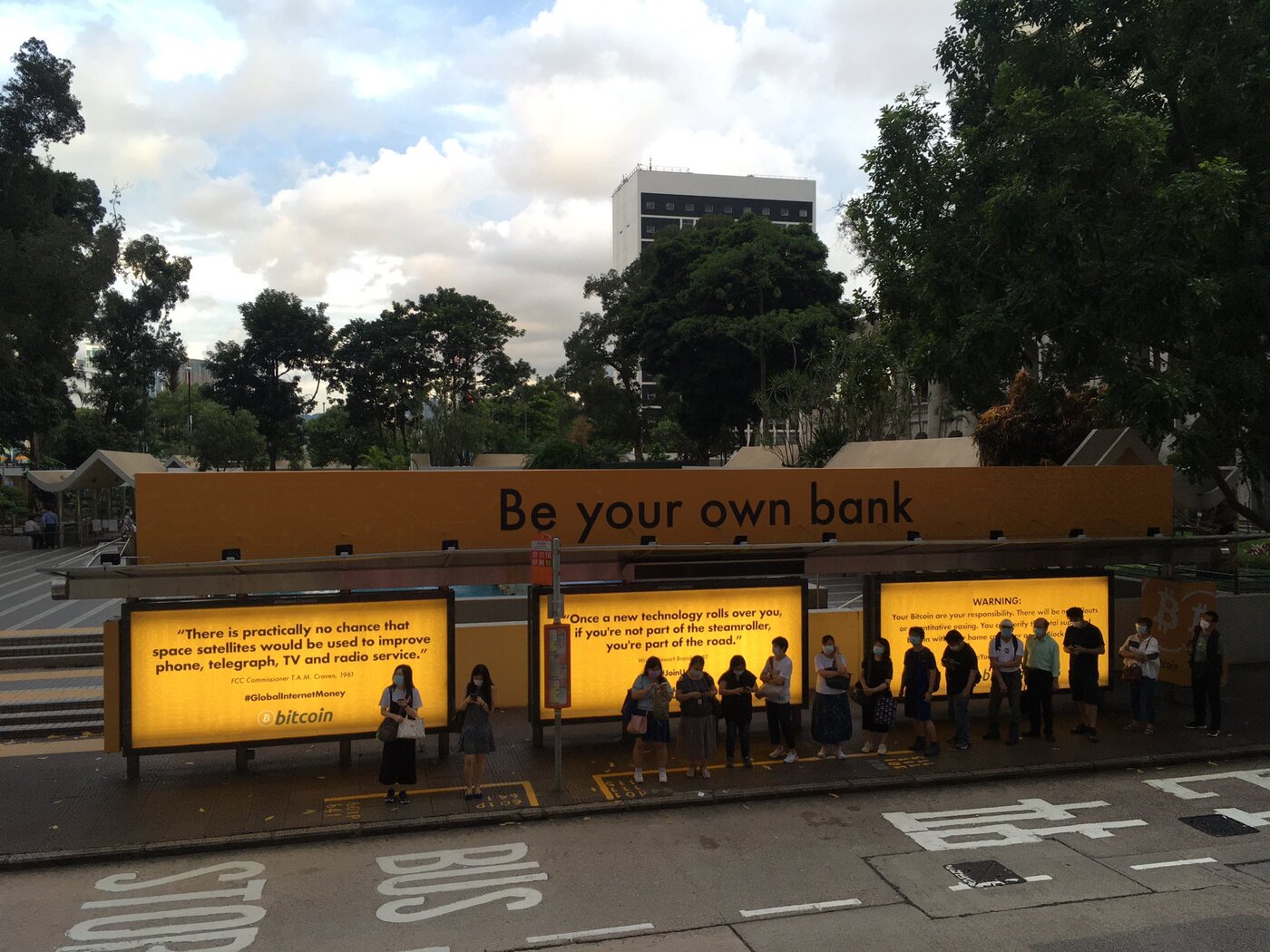 a bus stop with bitcoin ads