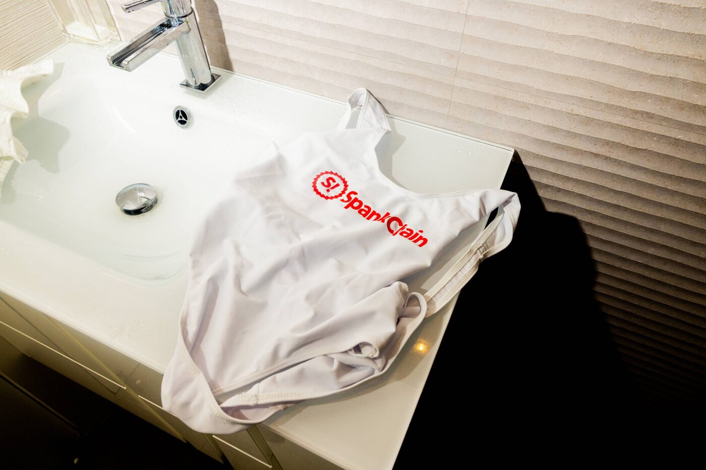 A SpankChain bikini sits on a bathroom sink at a house party during Bitcoin 2021 in Miami
