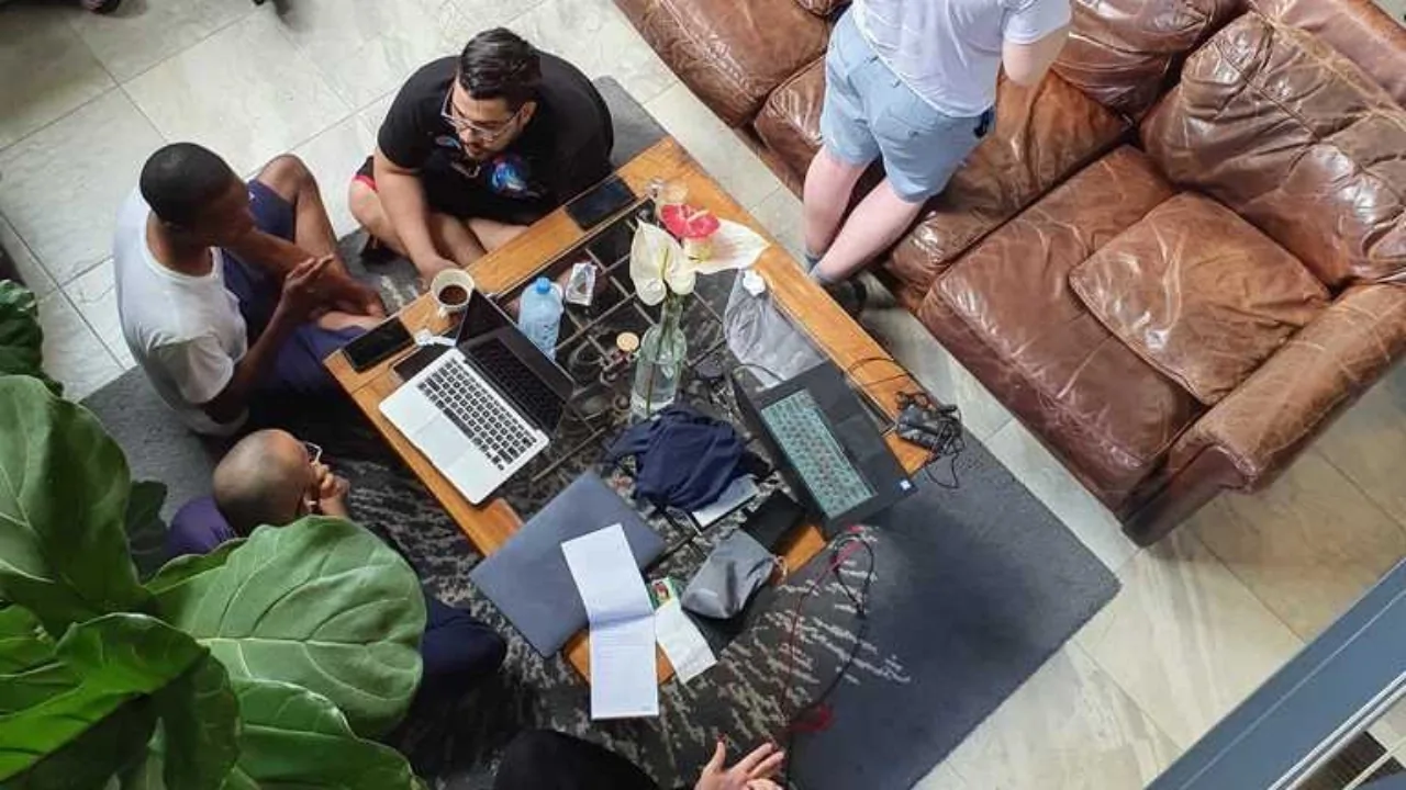 People sitting around a laptop computer