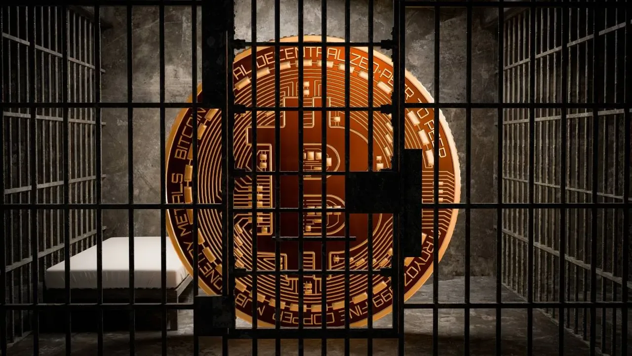 A gold bitcoin locked in a jail cell