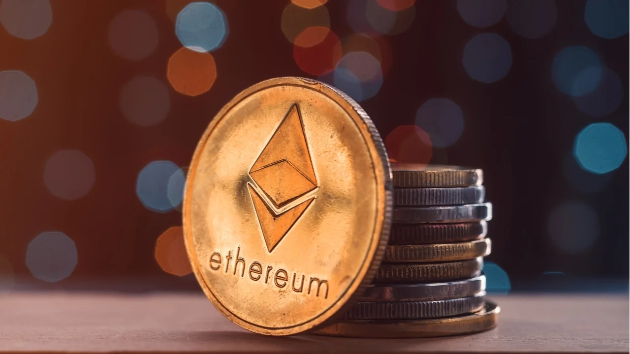 Ethereum coin leaning against a stack of coins